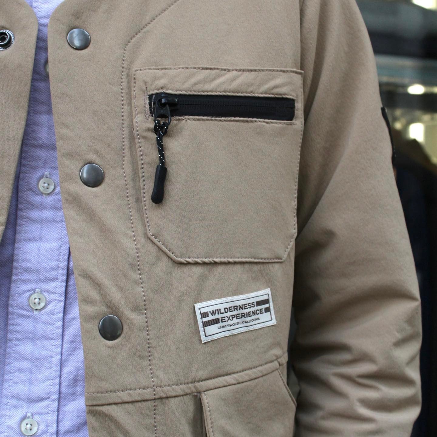WILDERNESS EXPERIENCE - STORAGE POCKET COLLARLESS JACKET